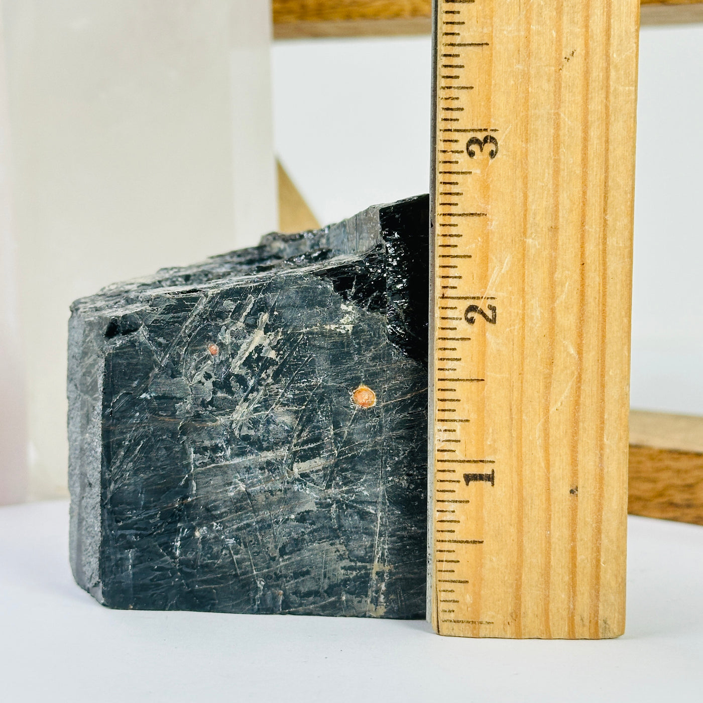 tourmaline point next to a ruler for size reference