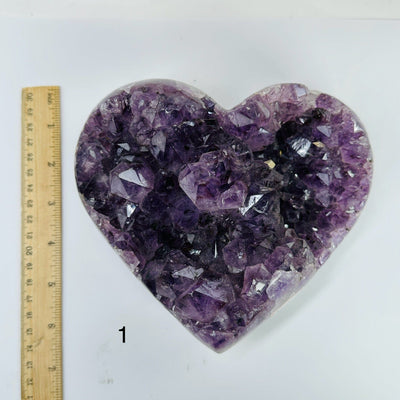 amethyst crystal heart next to a ruler for size reference