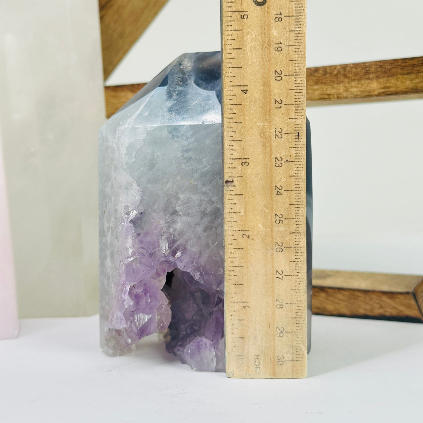 amethyst point next to a ruler for size reference