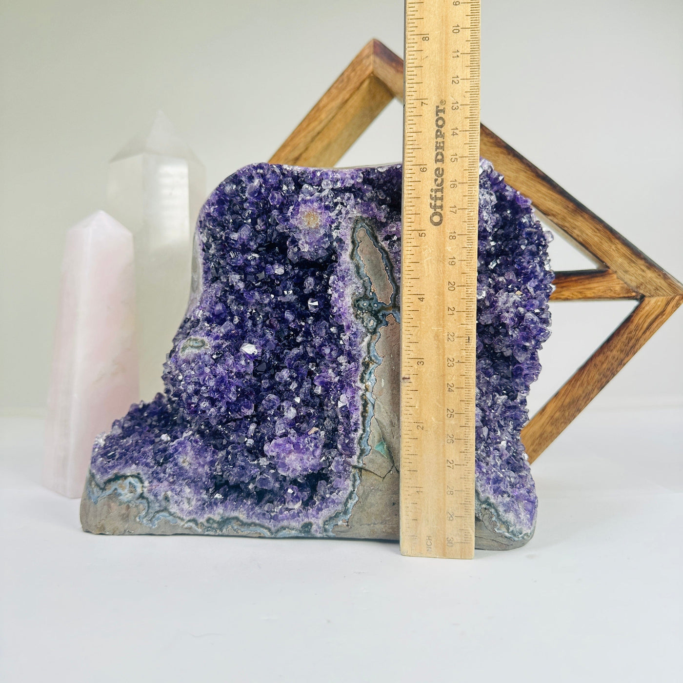 amethyst cluster next to a ruler for size reference