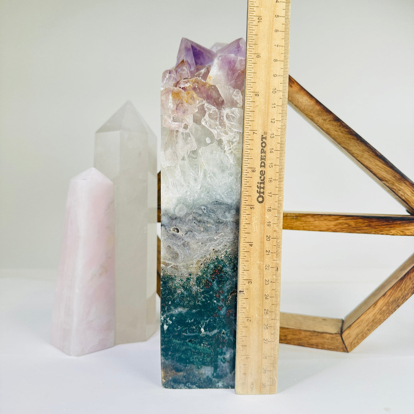 amethyst point next to a ruler for size reference