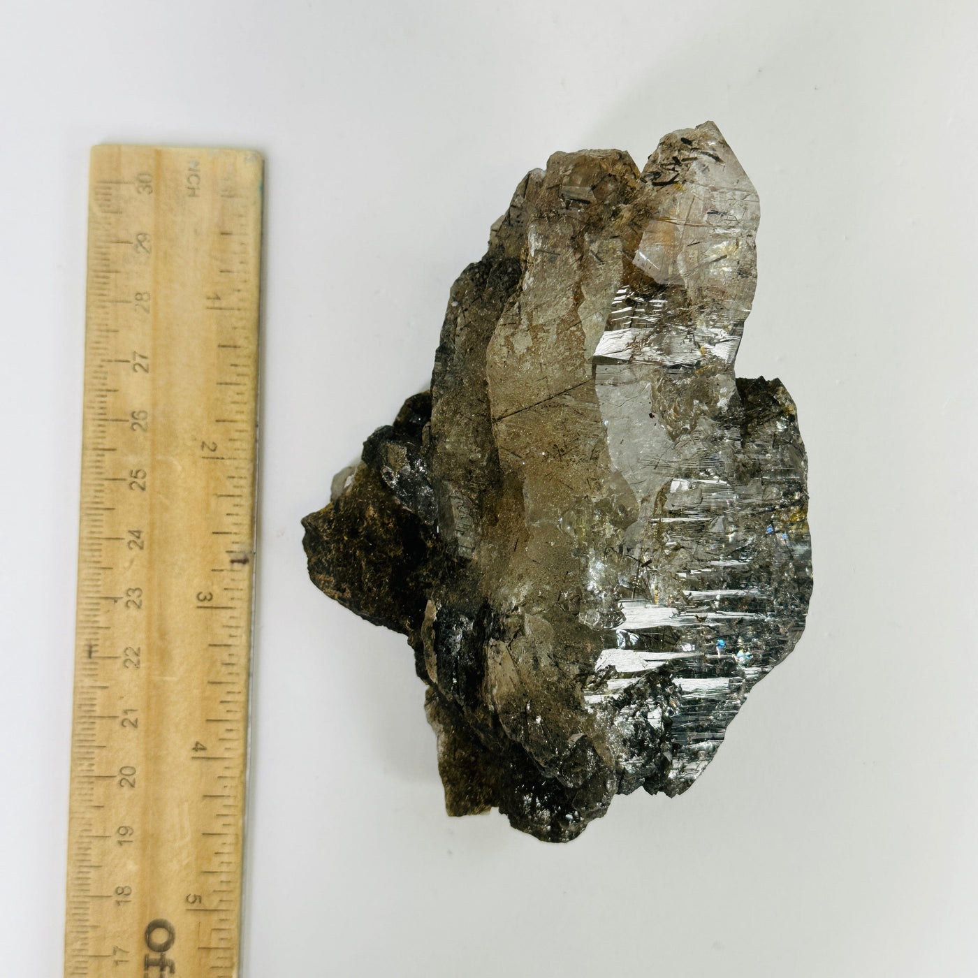 rutile quartz next to a ruler for size reference