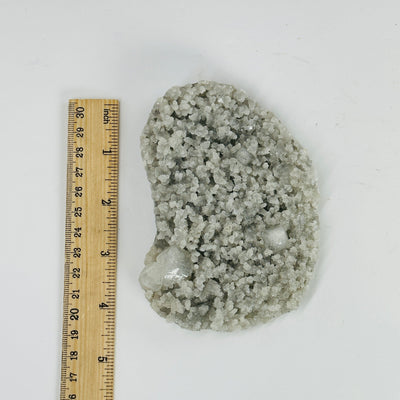 apophyllite slab next to a ruler for size reference