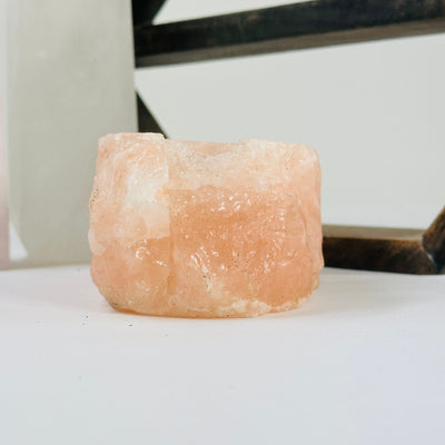 Himalayan salt candle holder with decorations in the background