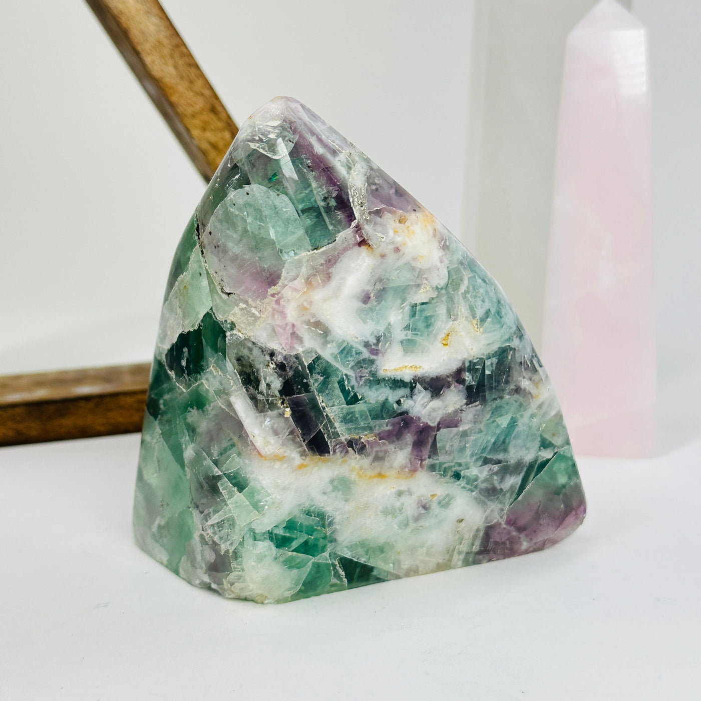 rainbow fluorite cut base with decorations in the background