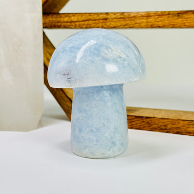 blue calcite mushroom with decorations in the background