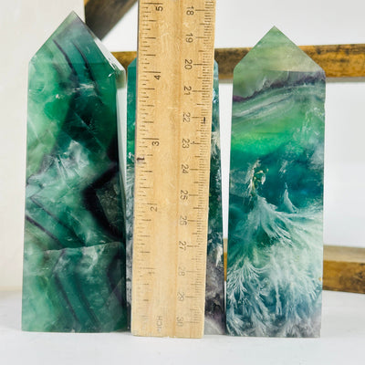 fluorite point next to a ruler for size reference