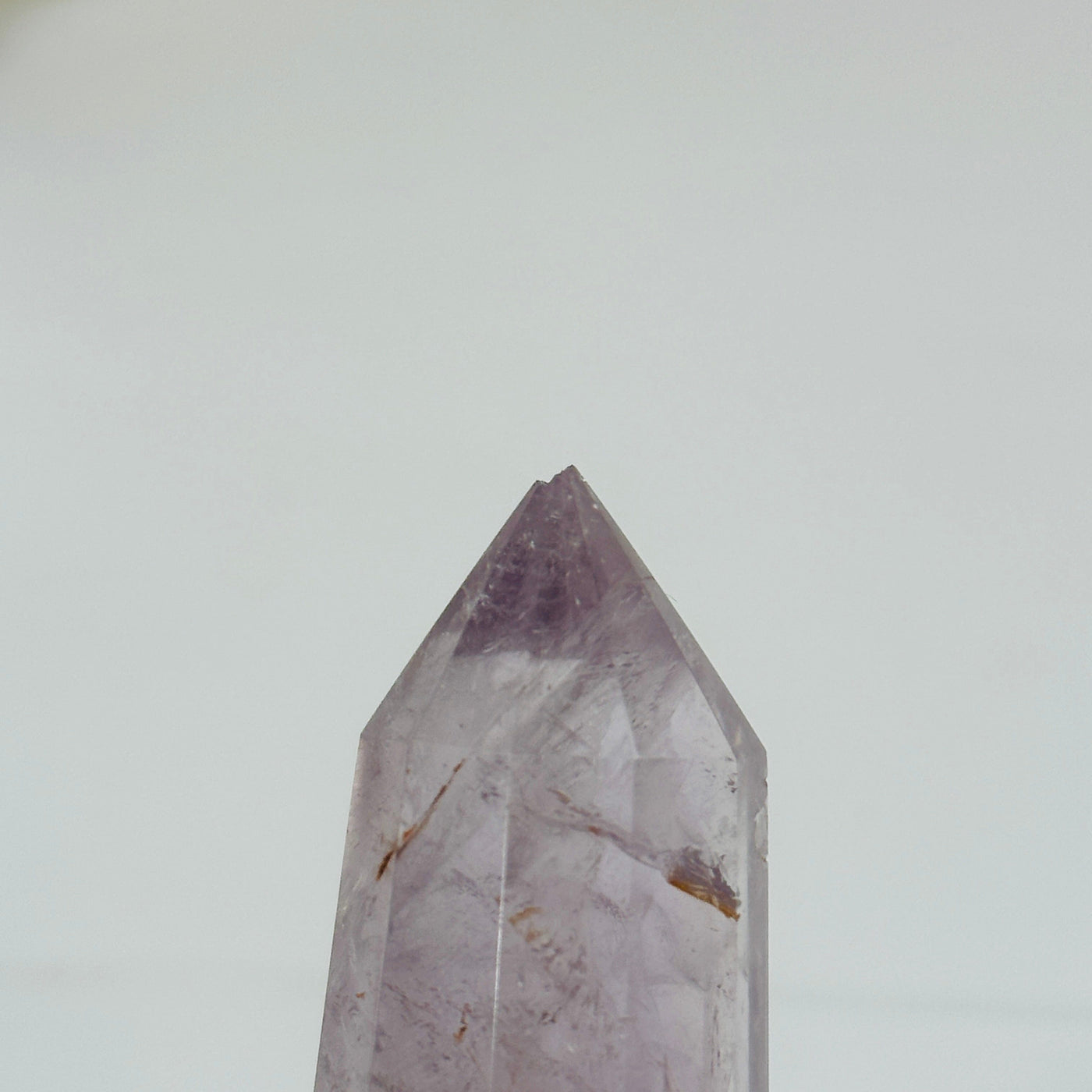 up close shot of chip on tip of amethyst wand