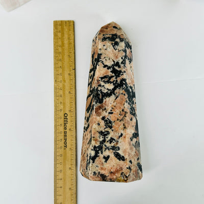 feldspar point next to a ruler for size reference