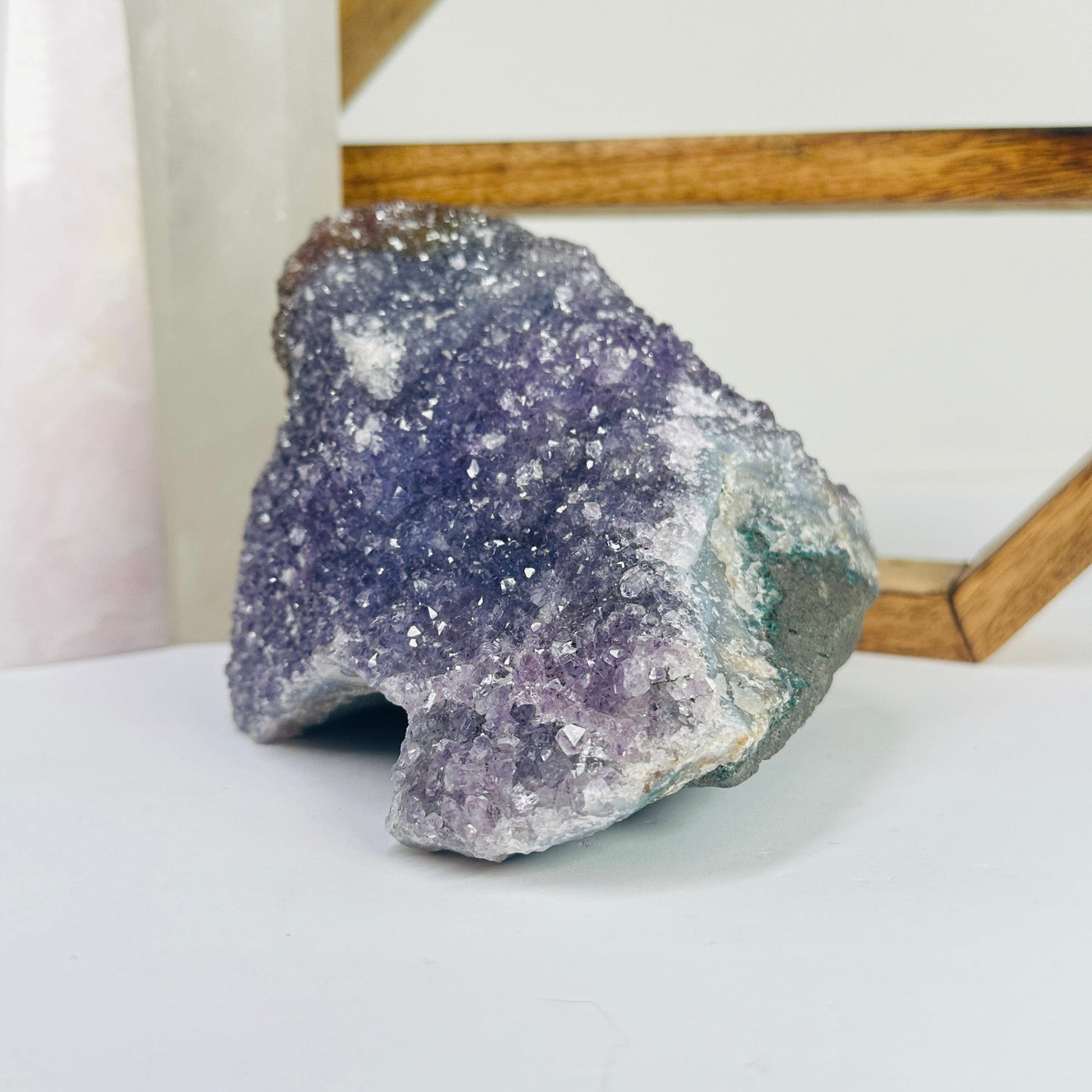 amethyst cluster with decorations in the background