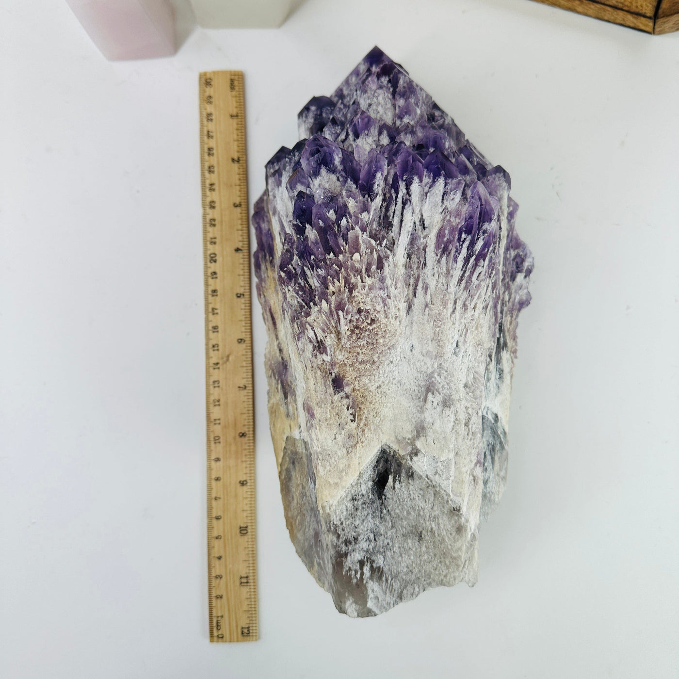 elestial amethyst next to ruler for size reference