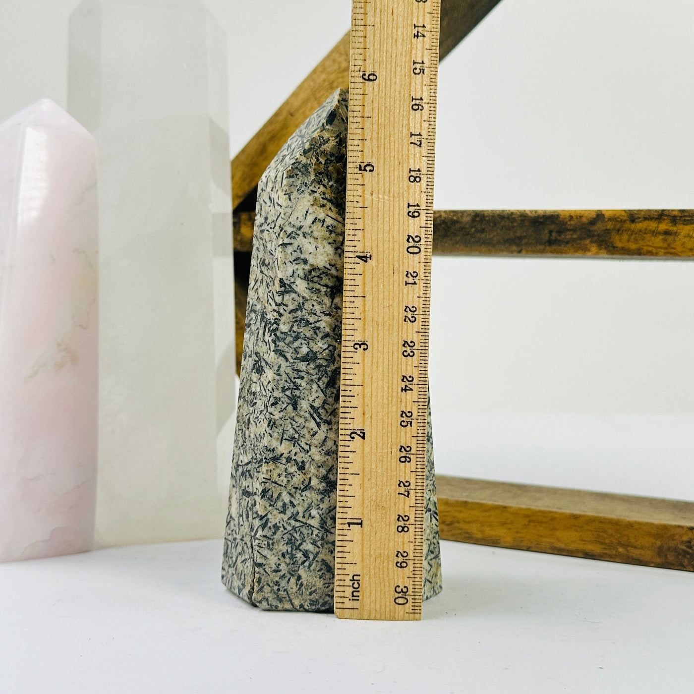 epidote point next to a ruler for size reference