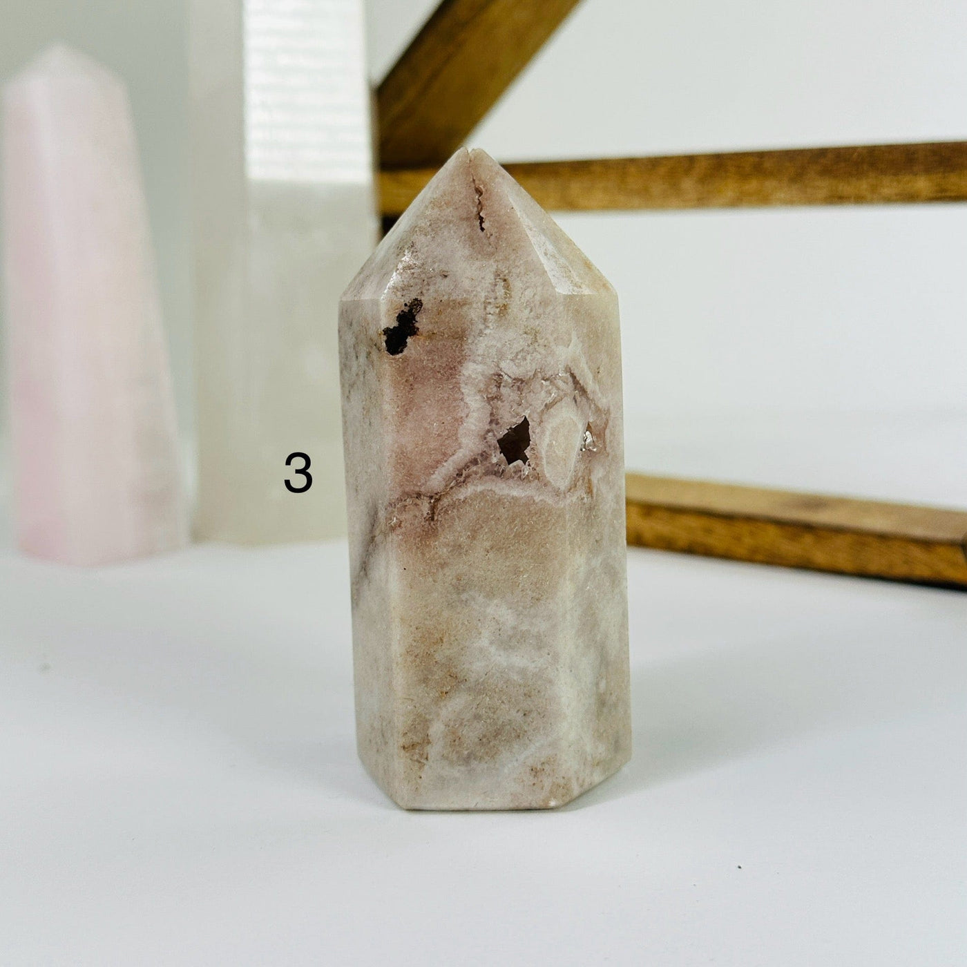 pink amethyst point with decorations in the background