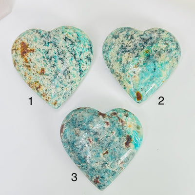 amazonite heart with decorations in the background