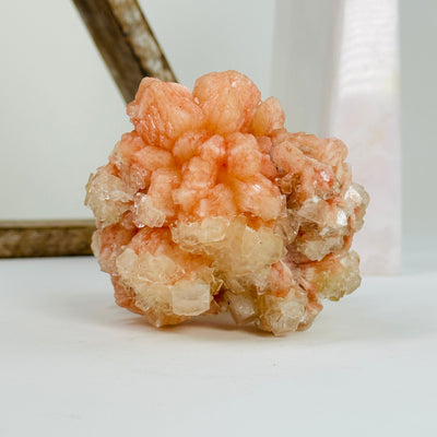 peach apophyllite with decorations in the background