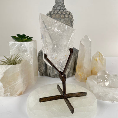 Crystal Quartz Polished Freeform on Metal Stand - One-of-a-Kind front view with props and plants in the background