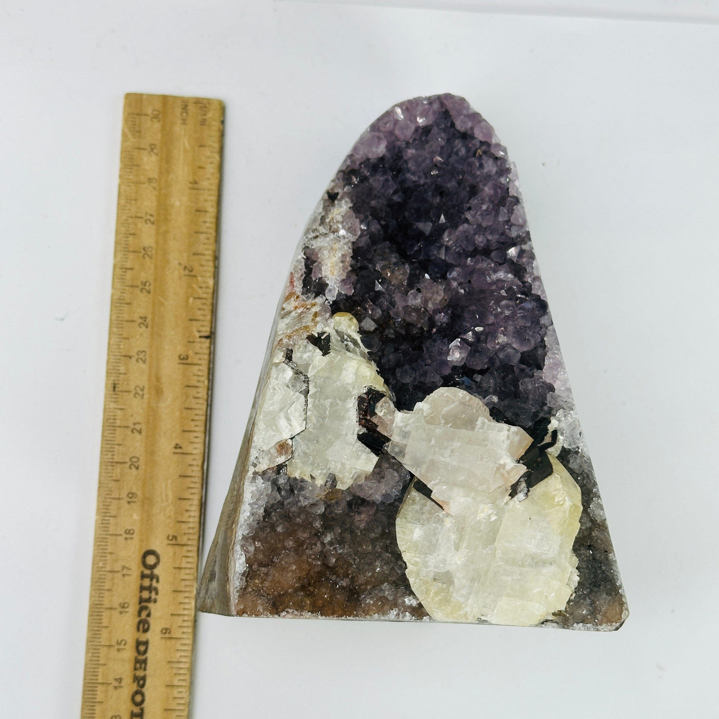 Amethyst cut base next to a ruler for size reference