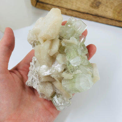 apophyllite cluster with decorations in the background