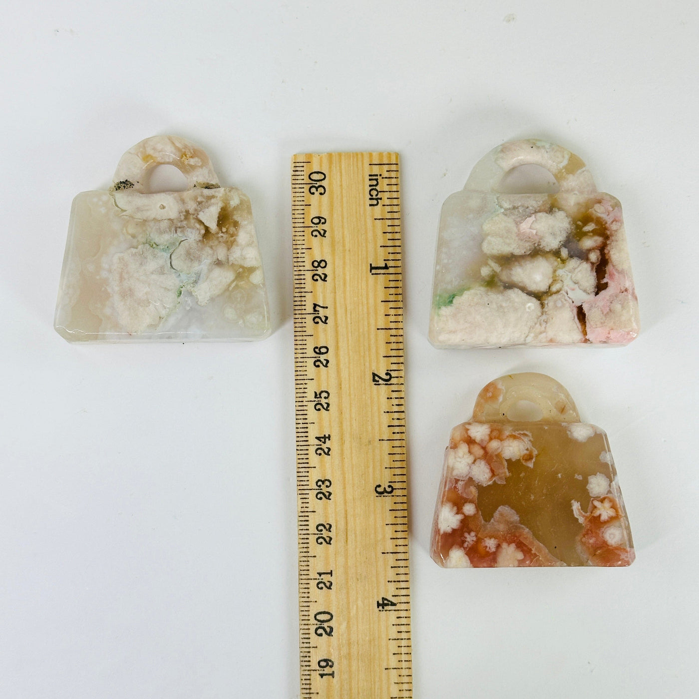 flower agate purse next to a ruler for size reference