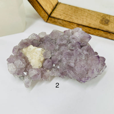 amethyst cluster with decorations in the background