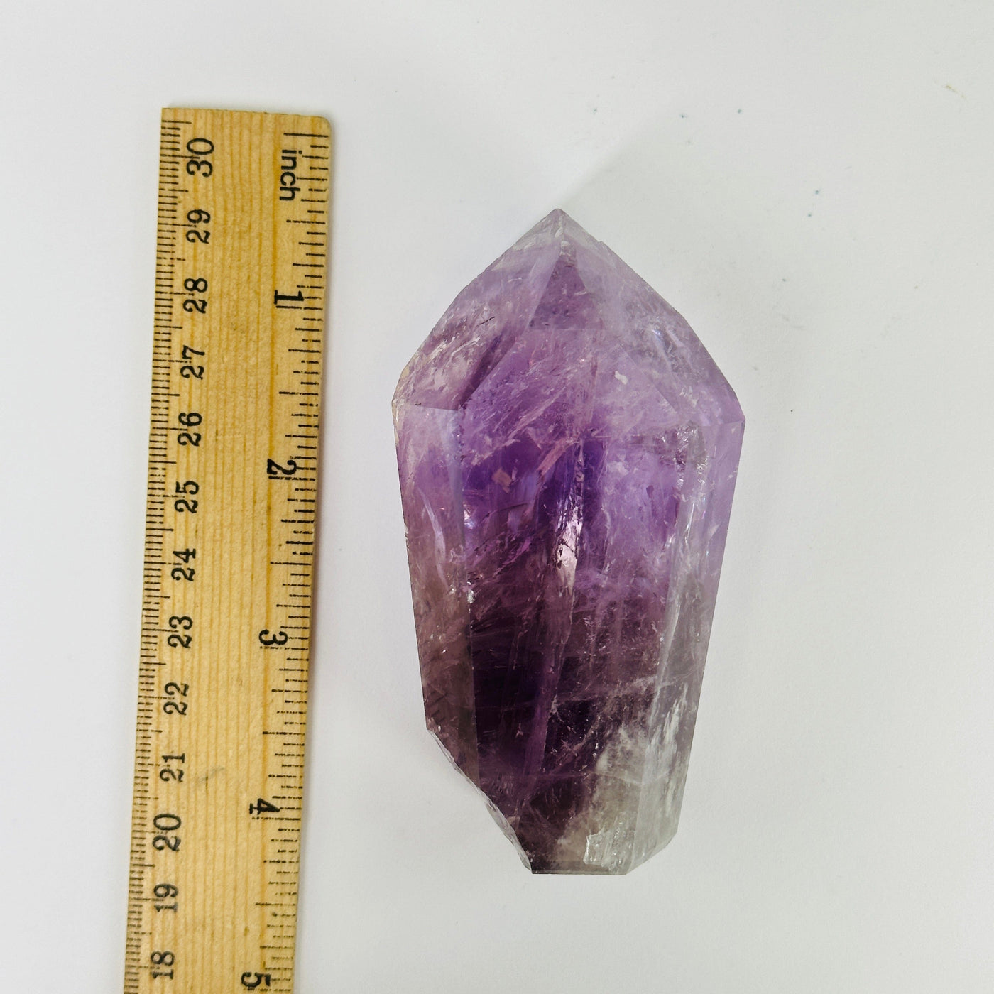 amethyst points next to a ruler for size reference