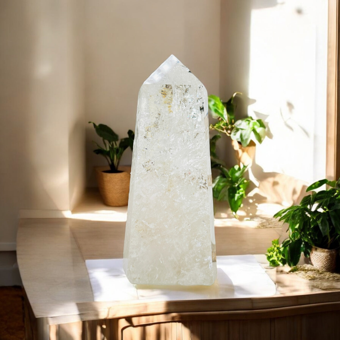 crystal quartz point with decorations in the background