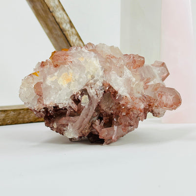 lithium quartz cluster with decorations in the background