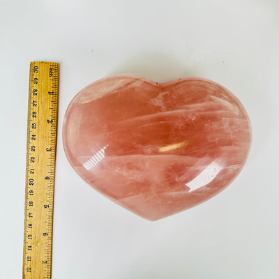 rose quartz heart with decorations in  the background