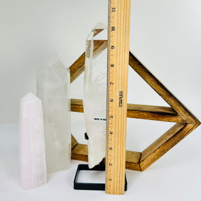 crystal quartz point next to a ruler for size reference