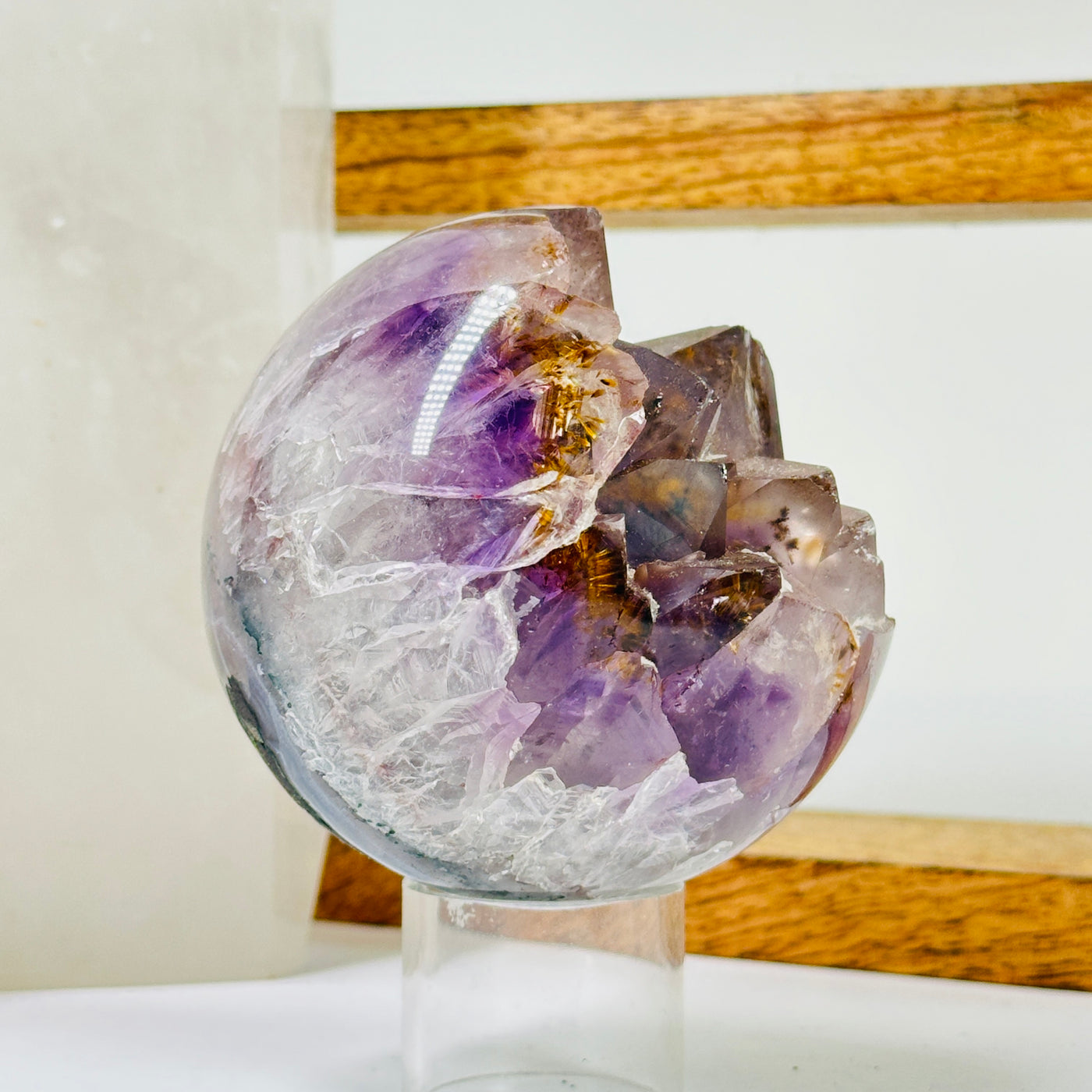 amethyst sphere with decorations in the background