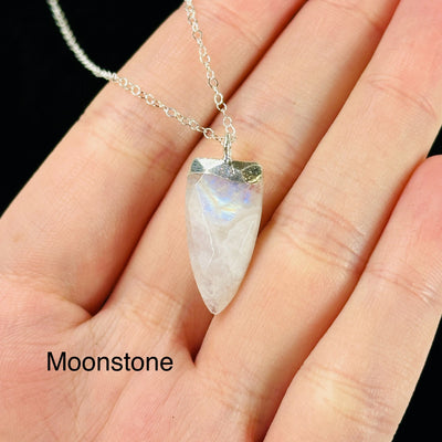 gemstone necklaces with decorations in the background