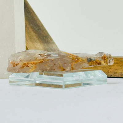 rutilated quartz with decorations in the background