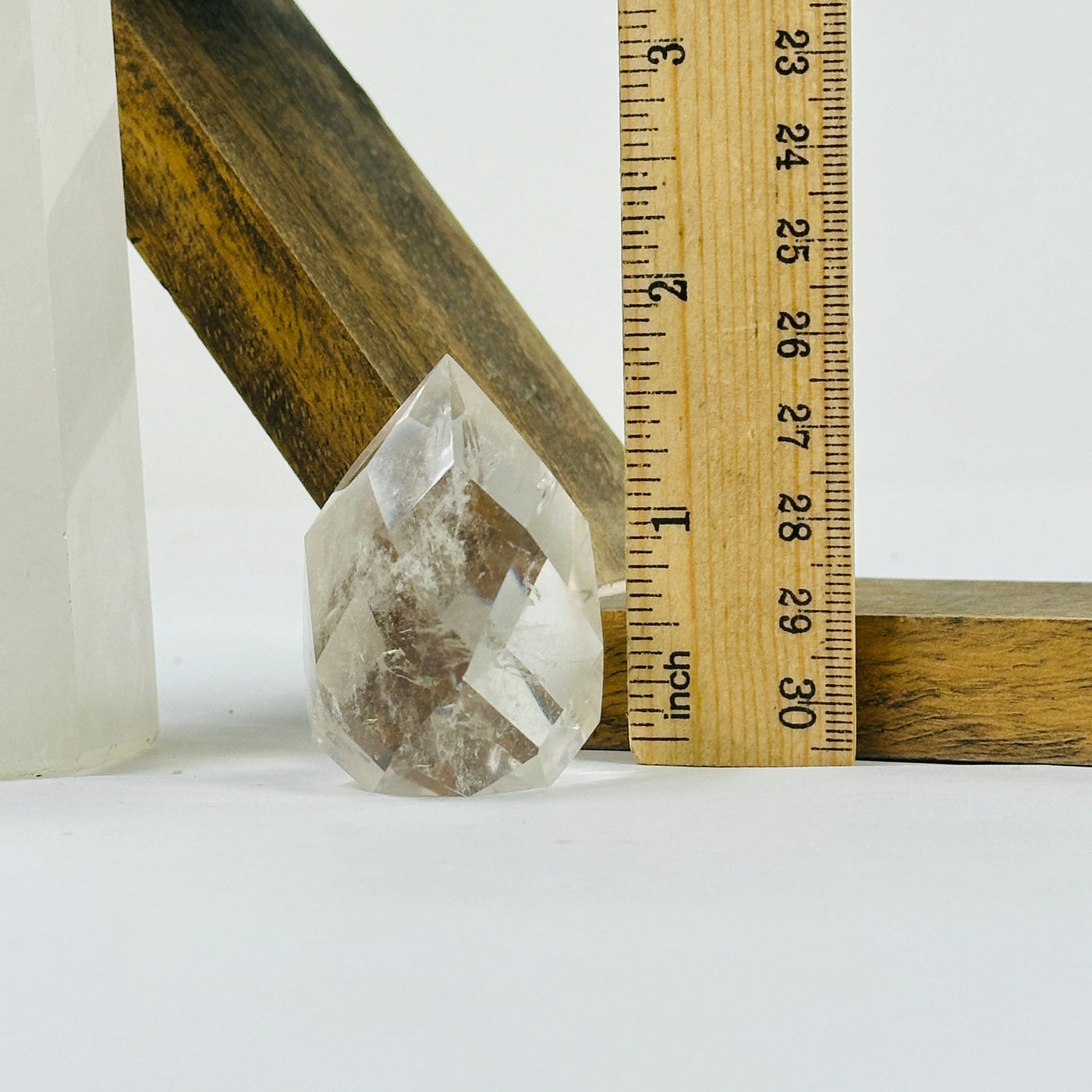 crystal quartz point with decorations in the background