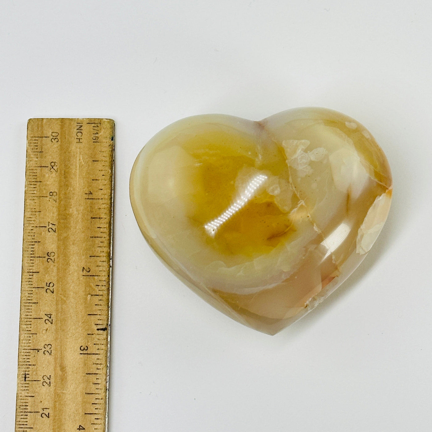 carnelian heart next to a ruler for size reference