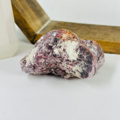 lepidolite cluster with decorations in the background