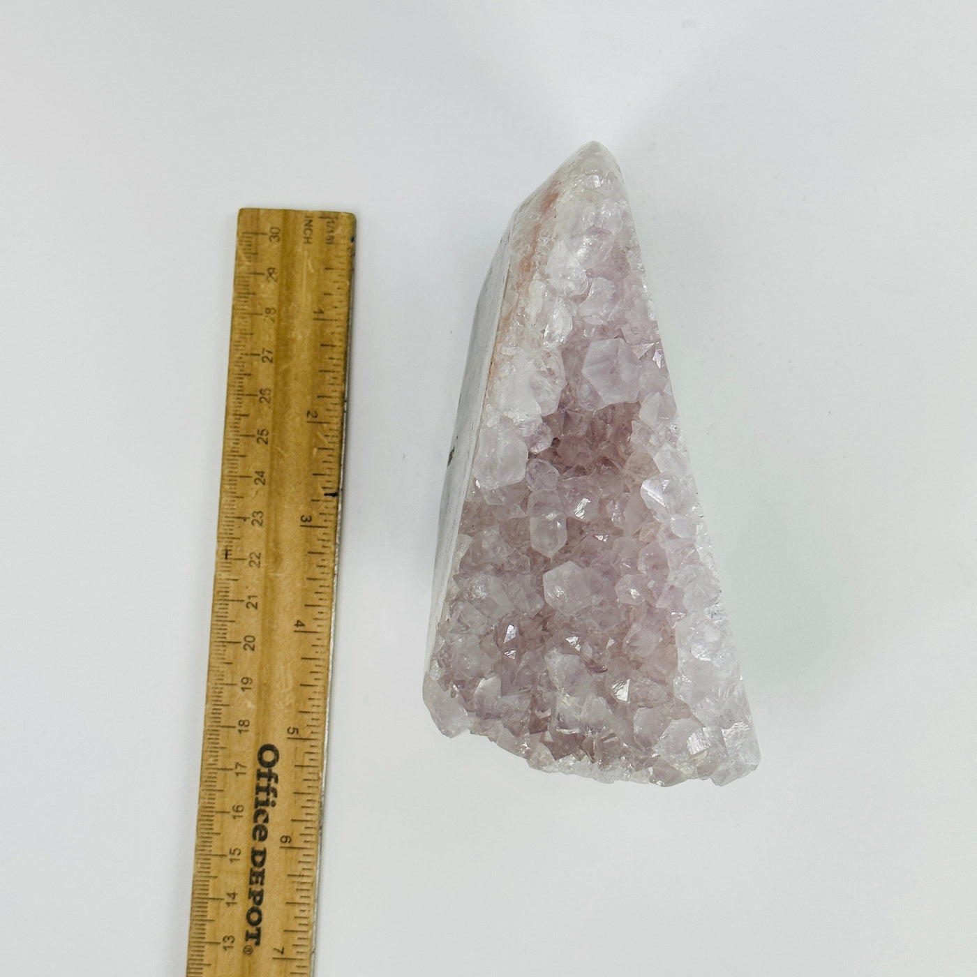 amethyst stalactite cut base next to a ruler for size reference
