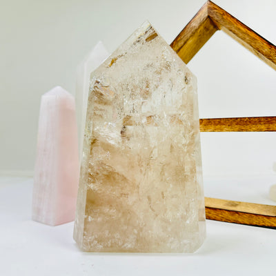 crystal quartz point with decorations in the background