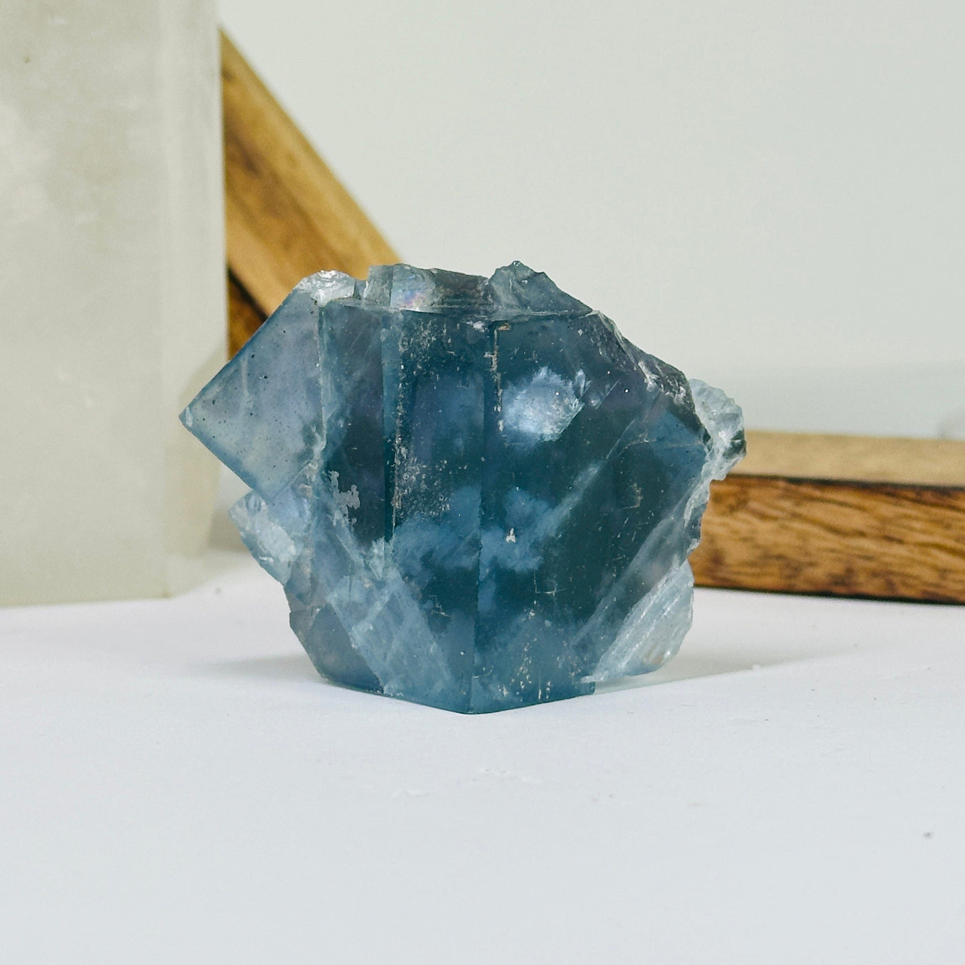 Blue fluorite crystal with decorations in the background