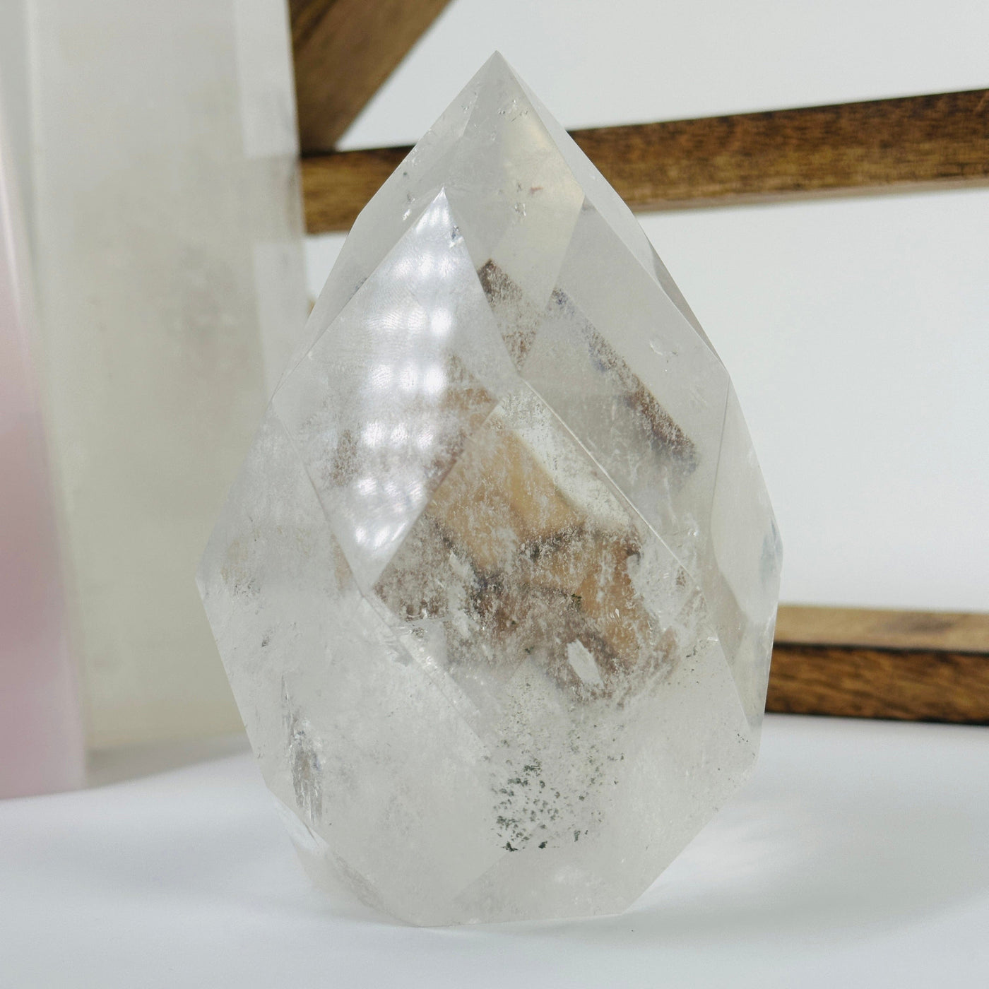 crystal quartz faceted egg with decorations in the background