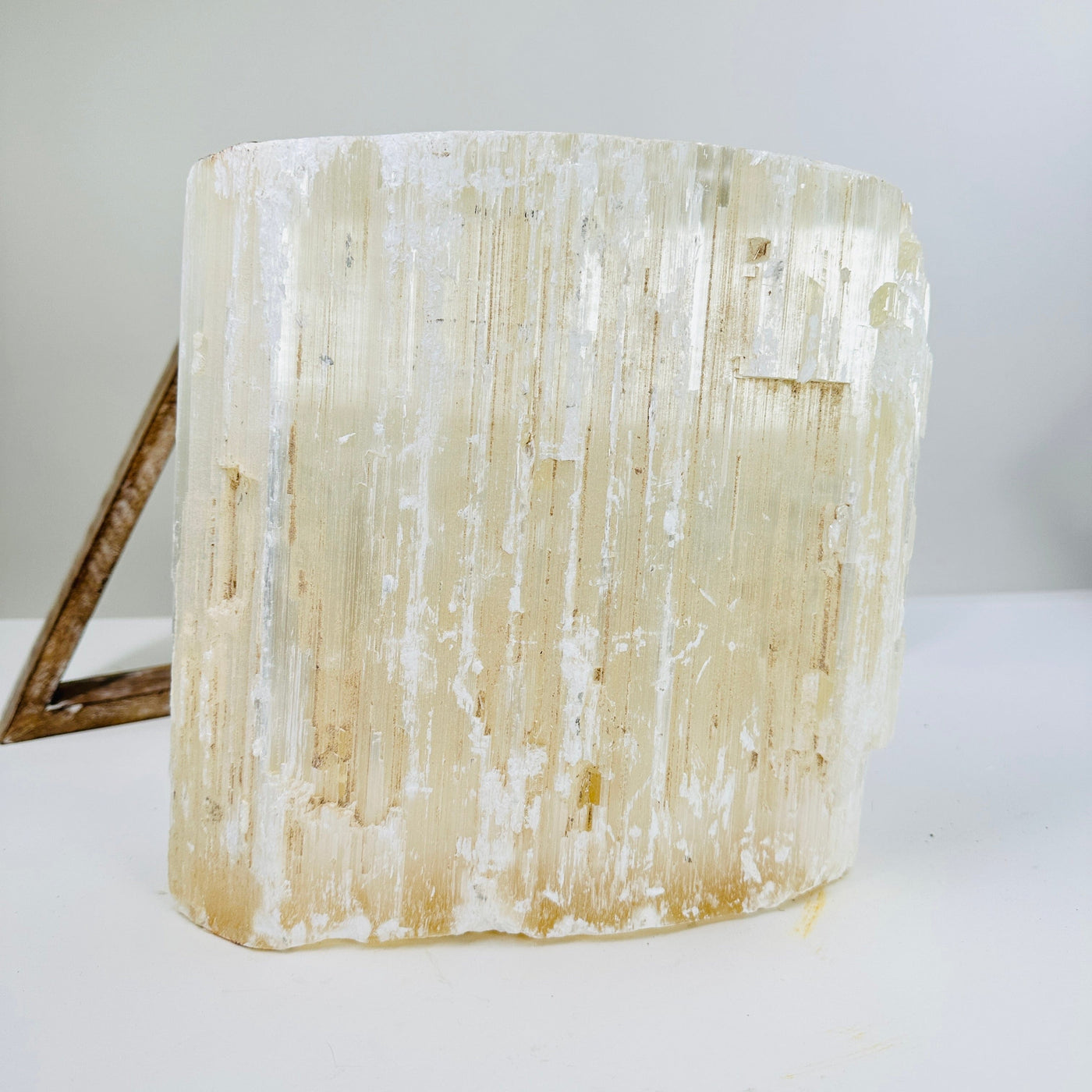 selenite cluster with decorations in the background