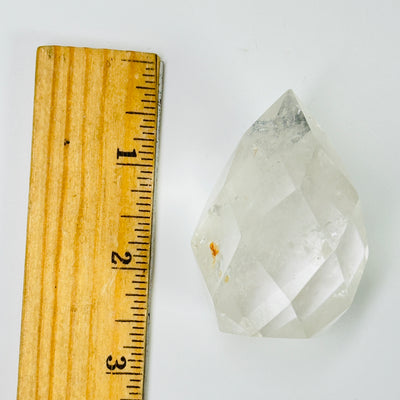 crystal quartz egg next to a ruler for size reference