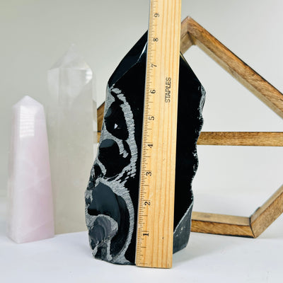 obsidian base next to a ruler for size reference