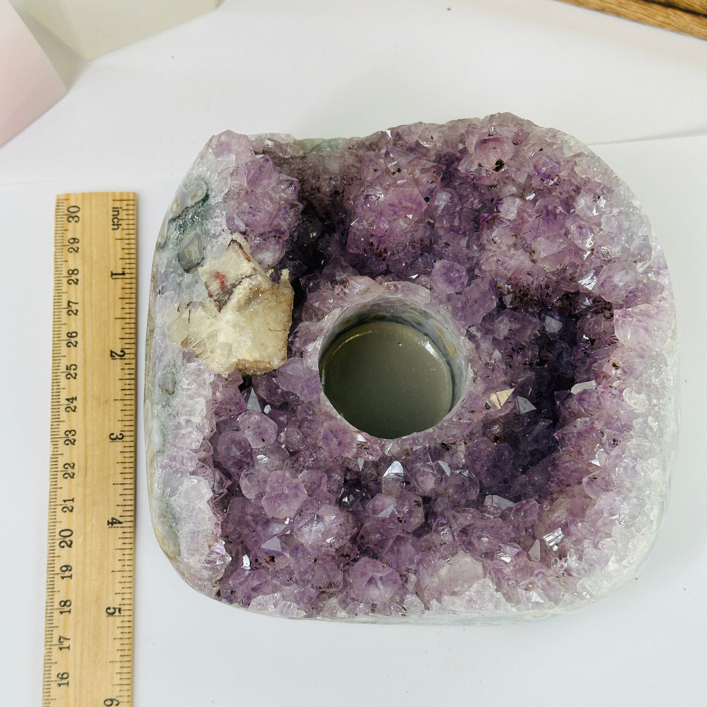 amethyst candle holder next to a ruler for size reference