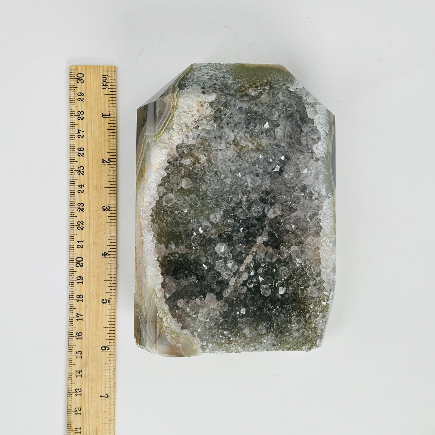 natural agate druzy point next to a ruler for size reference
