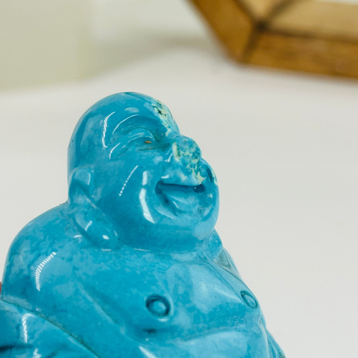 up close shot of chip on buddha statue