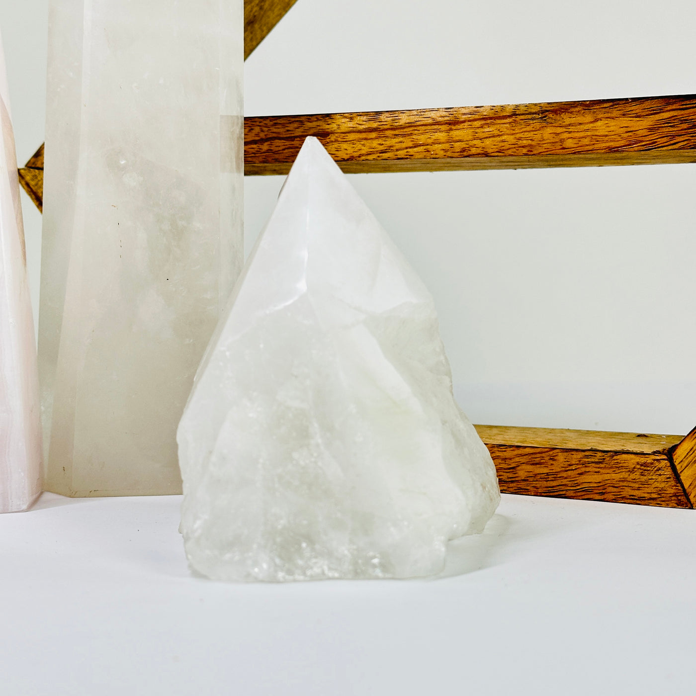 crystal quartz point with decorations in the background