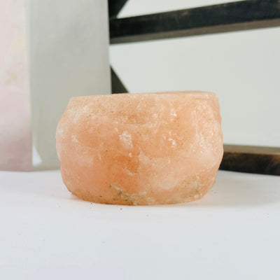 Himalayan salt candle holder with decorations in the background