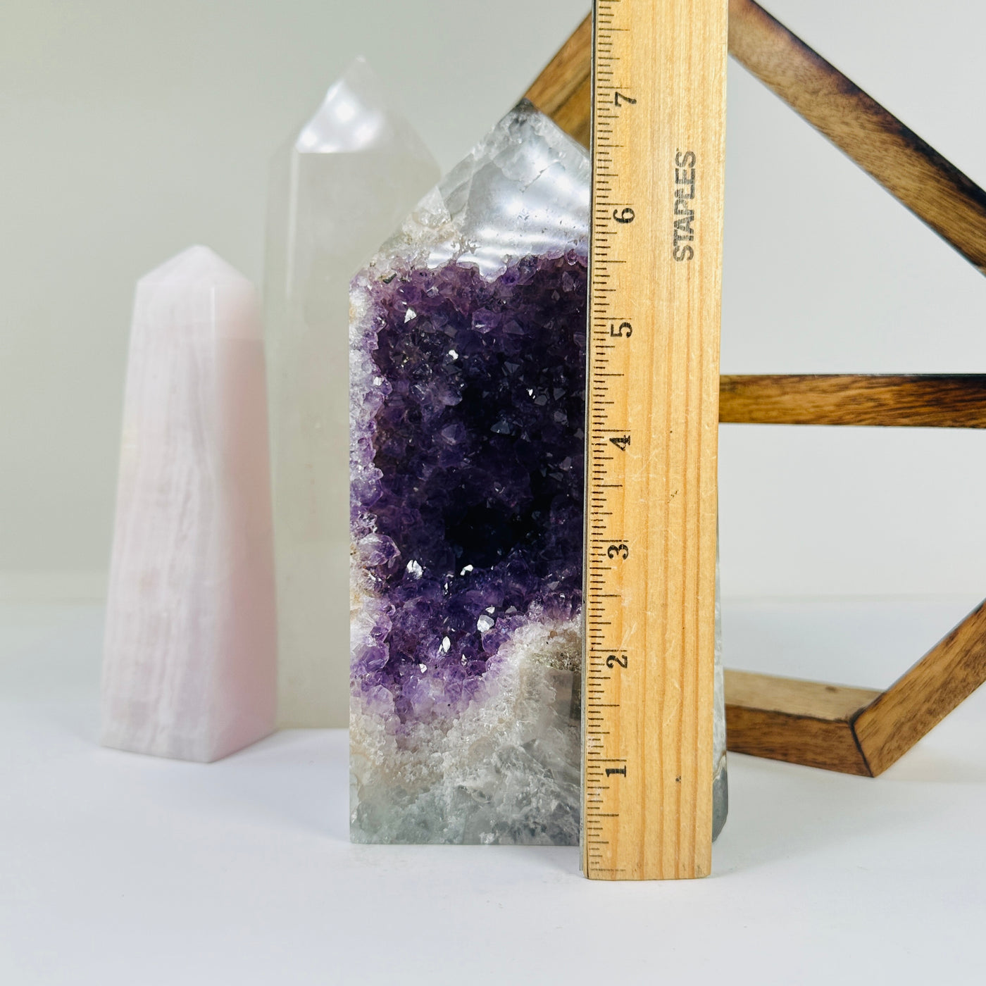 amethyst point next to a ruler for size reference