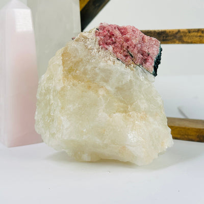 watermelon tourmaline with decorations in the background