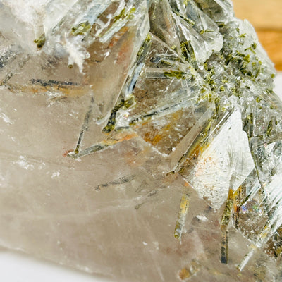 tourmaline on alligator quartz with decorations in the background